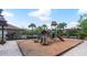 Community playground on a mulch bed with slides, climbing areas, and shade covering in a fenced-in area at 976 Eagle Bay St, Winter Springs, FL 32708