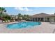 Community swimming pool surrounded by chairs and a covered area for residents enjoyment at 976 Eagle Bay St, Winter Springs, FL 32708