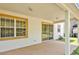 A covered back patio with sliding glass doors provides a relaxing extension of the home at 9836 Old Patina Way, Orlando, FL 32832