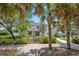Backyard featuring a covered patio, well-maintained lawn, and lush landscaping for outdoor enjoyment at 9836 Old Patina Way, Orlando, FL 32832