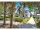 The backyard features a covered patio and walkway lined with lush landscaping, creating a private outdoor space at 9836 Old Patina Way, Orlando, FL 32832