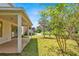 Spacious backyard with covered patio, mature trees and views of the nearby lake at 9836 Old Patina Way, Orlando, FL 32832