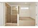 Updated bathroom featuring a glass-enclosed shower and a soaking tub at 9836 Old Patina Way, Orlando, FL 32832