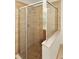 Bathroom showcasing frameless shower and stone tile at 9836 Old Patina Way, Orlando, FL 32832