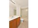 Well-lit bathroom featuring wood cabinets, a large mirror, and a shower-tub combination at 9836 Old Patina Way, Orlando, FL 32832
