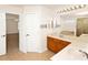 Bathroom with tile floors, double sink vanity, large mirror and open doorway to carpeted bedroom at 9836 Old Patina Way, Orlando, FL 32832
