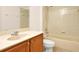 Cozy bathroom with bathtub, shower, tiled walls, single sink and neutral decor at 9836 Old Patina Way, Orlando, FL 32832
