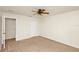 Comfortable bedroom with a ceiling fan, carpet floors, and closet for ample storage at 9836 Old Patina Way, Orlando, FL 32832