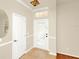 Inviting foyer features tile flooring, transom window and a decorative glass front door for added elegance at 9836 Old Patina Way, Orlando, FL 32832