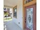 Decorative glass front door framed by sidelight and porch, adding curb appeal at 9836 Old Patina Way, Orlando, FL 32832