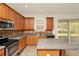 Open kitchen featuring stainless steel appliances, island and access to outside patio at 9836 Old Patina Way, Orlando, FL 32832