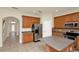 Kitchen featuring stainless steel appliances, wood cabinets, an island and natural lighting at 9836 Old Patina Way, Orlando, FL 32832