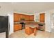 Kitchen featuring wood cabinets, stainless appliances, and an island for food preparation at 9836 Old Patina Way, Orlando, FL 32832