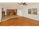 Open kitchen leading into living room featuring stainless appliances and wood cabinets at 9836 Old Patina Way, Orlando, FL 32832