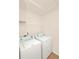 Bright laundry room featuring side by side washer and dryer hookups and a shelf for storage at 9836 Old Patina Way, Orlando, FL 32832