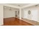 Open-concept living room boasts gleaming hardwood floors, neutral walls, and ample natural light at 9836 Old Patina Way, Orlando, FL 32832