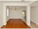 Living room featuring hardwood floors, neutral walls, and an elegant light fixture at 9836 Old Patina Way, Orlando, FL 32832