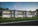 Attractive townhouse exterior features a well-manicured lawn and a light gray and white color scheme at 10234 Hadley St, Orlando, FL 32829