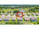 This aerial image highlights the home's central location within a neighborhood with a serene pond backdrop at 10249 Spring Lake Dr, Clermont, FL 34711