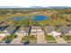 Beautiful aerial view of homes on the golf course with a serene pond in the background at 10249 Spring Lake Dr, Clermont, FL 34711