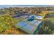 Aerial shot of tennis courts and pool offers a glimpse of recreation options within the community at 10249 Spring Lake Dr, Clermont, FL 34711