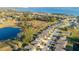 An aerial panorama displays homes near a lake, integrating peaceful living with scenic waterfront views at 10249 Spring Lake Dr, Clermont, FL 34711