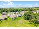 Aerial view of a home showcasing the lawn and landscaping, with community views at 10249 Spring Lake Dr, Clermont, FL 34711