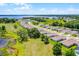 An aerial view shows the community's houses, complemented by beautiful landscaping and scenic lake views at 10249 Spring Lake Dr, Clermont, FL 34711