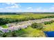 An aerial view showcases this community's well-planned layout with homes surrounded by lush greenery and waterways at 10249 Spring Lake Dr, Clermont, FL 34711