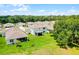 An aerial view of a backyard and covered lanai in a well-manicured lawn at 10249 Spring Lake Dr, Clermont, FL 34711