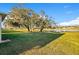 Beautiful view of the backyard leading to a lake with lots of shade trees at 10249 Spring Lake Dr, Clermont, FL 34711