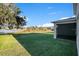 Large green backyard leads to the lake in this attractive home at 10249 Spring Lake Dr, Clermont, FL 34711