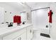 Bright bathroom with double sink vanity, framed mirrors, modern fixtures, and a bathtub with shower at 10249 Spring Lake Dr, Clermont, FL 34711