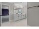Bright bathroom features a double sink vanity with modern fixtures and a view to the Primary bedroom at 10249 Spring Lake Dr, Clermont, FL 34711