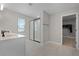 Elegant bathroom with a glass-enclosed shower and a double sink vanity with white countertops at 10249 Spring Lake Dr, Clermont, FL 34711