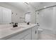 Modern bathroom features a double sink vanity, subway tile shower, and neutral color palette at 10249 Spring Lake Dr, Clermont, FL 34711