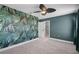 Stylish bedroom with leafy wallpaper, ceiling fan, plush carpets, and an attached closet at 10249 Spring Lake Dr, Clermont, FL 34711