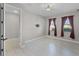 Inviting bedroom with tile floors, two windows, and an adjacent room visible through the doorway at 10249 Spring Lake Dr, Clermont, FL 34711