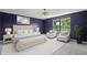 Staged bedroom showcasing a comfortable bed, decorative side tables, and scenic backyard view at 10249 Spring Lake Dr, Clermont, FL 34711
