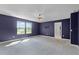Large bedroom with backyard views from two windows and doorways to other areas of the home at 10249 Spring Lake Dr, Clermont, FL 34711