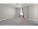 An airy bedroom with plush carpeting and a light neutral paint palette plus attached closet at 10249 Spring Lake Dr, Clermont, FL 34711