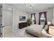 A beautifully designed bedroom features a comfortable bed, TV and stylish furnishings at 10249 Spring Lake Dr, Clermont, FL 34711