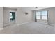 An airy bonus room offers lots of natural light and plush carpeting and neutral paint at 10249 Spring Lake Dr, Clermont, FL 34711