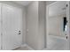 Welcoming entryway with a white front door and view into the room with light flooring at 10249 Spring Lake Dr, Clermont, FL 34711