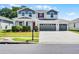 Charming two-story home features a three car garage and beautifully landscaped front yard at 10249 Spring Lake Dr, Clermont, FL 34711