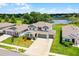 A charming two-story home showcasing manicured landscaping and a three-car garage at 10249 Spring Lake Dr, Clermont, FL 34711