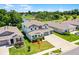 A charming two-story home showcasing manicured landscaping and a three-car garage at 10249 Spring Lake Dr, Clermont, FL 34711