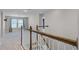 Bright hallway features a wooden staircase and an open floor plan with natural light at 10249 Spring Lake Dr, Clermont, FL 34711