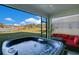 Back porch featuring a hot tub with views of the lake, trees, and beautiful blue sky at 10249 Spring Lake Dr, Clermont, FL 34711