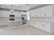 Modern kitchen with white cabinets, a center island, stainless steel appliances and sleek fixtures at 10249 Spring Lake Dr, Clermont, FL 34711
